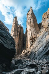 Tall rock formations, dark stones, blue sky.