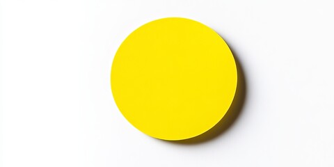A yellow circular paper sticker label isolated on a white background
