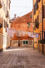 Italy, Venice. Arsenale neighborhood, Castello district. Laundry hanging to dry between buildings.