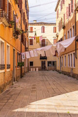 Italy, Venice. Arsenale neighborhood, Castello district. Laundry hanging to dry between buildings.