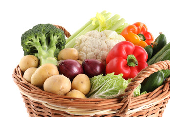 Different ripe vegetables in basket isolated on white