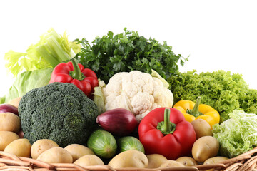 Many different ripe vegetables in basket isolated on white