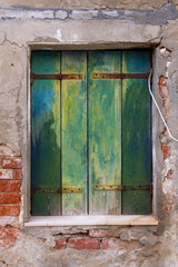 Italy, Venice. Castello district. Window with green wooden shutters.