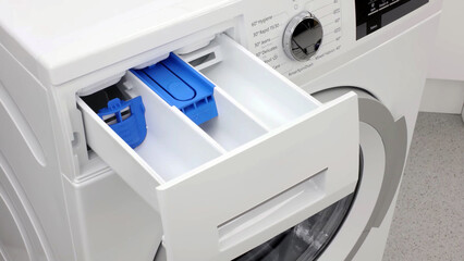 New and clean washing machine detergent and fabric conditioner dispenser close-up