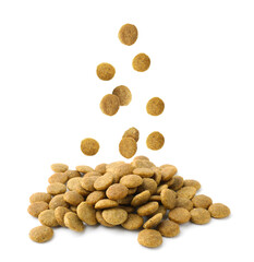 Dry pet food falling onto heap on white background