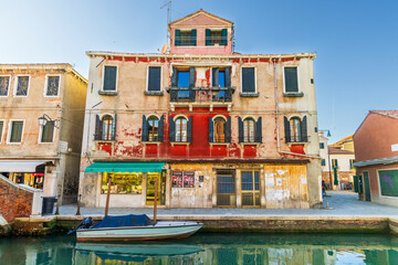 Italy, Murano. Canal and colorful buildings the island is known for.