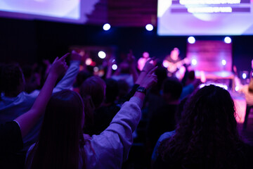 People Worshipping at a Church Service with Hands Raised in Praise