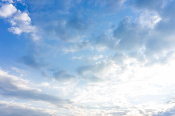 Bright clouds drifting in a clear blue sky during midday sunlight