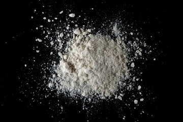Organic coconut flour isolated on black, top view, clipping