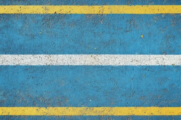A colorful sports court with a light blue rubber field and white and yellow lines, seen from above