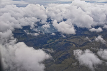 Iceland from airplane through clouds. Aerial scenic view of Iceland landscape. Travel vacation concept. Europe.