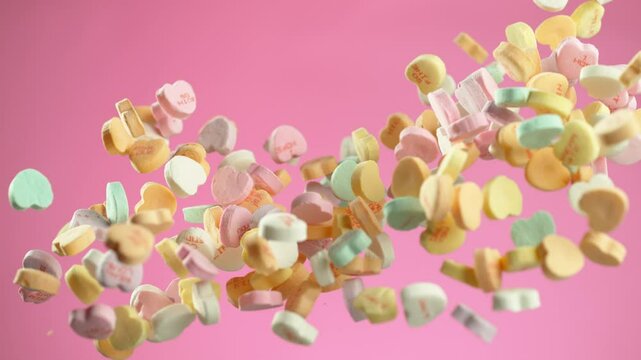 Heart shaped Valentine's Day candy flying in slow motion