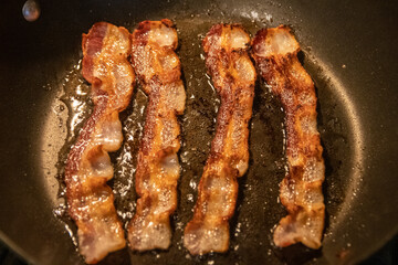 bacon frying in a pan