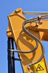 The yellow crane is a manipulator with a hydraulic cylinder. 
