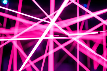Abstract pink neon light lines intersecting, creating a vibrant and energetic visual. Ideal for backgrounds, design, or technology concepts.