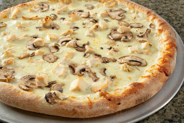 A view of a chicken mushroom pizza.