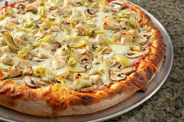 A view of a chicken artichoke pizza.