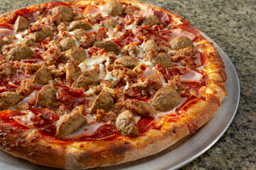 A view of a meaty pizza.