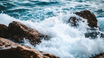 Fototapeta premium Vibrant Waves Against Rocky Shore in Bright Light