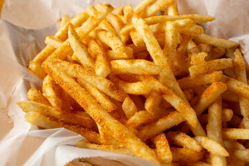 A view of a basket of cajun fries.