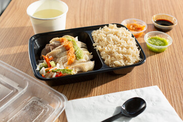 A view of a container of Hainanese chicken rice.