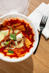 A top down view of a bowl of tteokbokki soup.