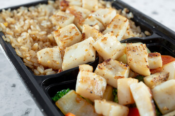 A closeup view of a grilled squid bowl.
