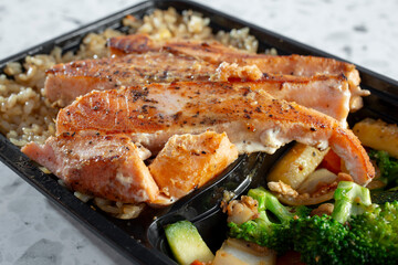 A closeup view of a grilled salmon bowl.