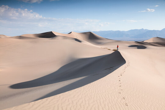 Man on a sand dune at Mesquite Flat Sand Dunes, Death valley National Park, California, United States