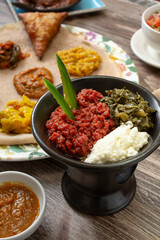 A view of a bowl of kitfo, among other Ethiopian entrees.