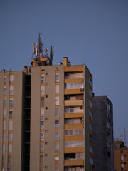 Cellular antennas and transmitters on roof of residential building. Radio transmitting equipment and communication lines on roof. 5G antennas. Evening sunset sky. Pula, Croatia - January 3, 2025