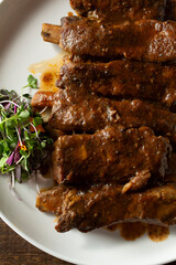 A top down view of a plate of BBQ pork ribs.