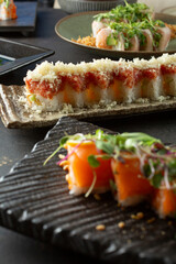 A closeup view of a crunchy roll, among other appetizers.
