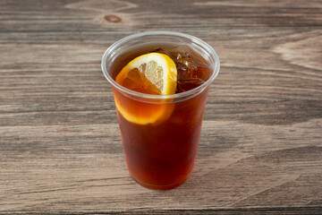 A view of a plastic cup filled with iced tea.