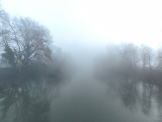 Winter landscape on foggy river. Poor visibility on the river due to fog