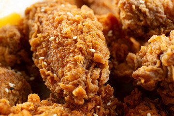 A closeup view of a pile of Korean fried chicken wings.