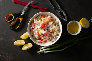 A top down view of a bowl full of king crab meat.
