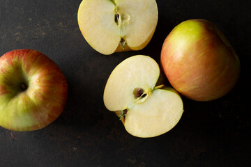 A top down view of some honeycrisp apples, featuring one that is halved.