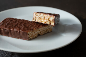 A view of a halved chocolate candy bar, on a plate.