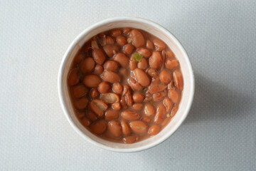 A top down view of a cup of pinto beans.
