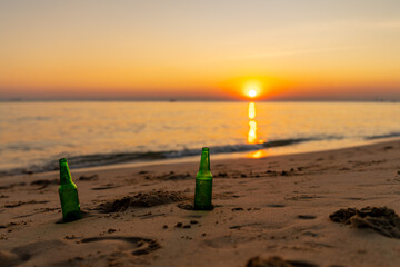 Summer travel on beach holiday vacation. Landscape of Tropical island ocean with beer bottle on sand beach at sunset. People enjoy outdoor active lifestyle travel nature and relaxing at the sea.