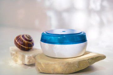 Cosmetics product with snail mucin. Mockup of cream jar. Packaging for cosmetics. Concept of skin care and advertising.