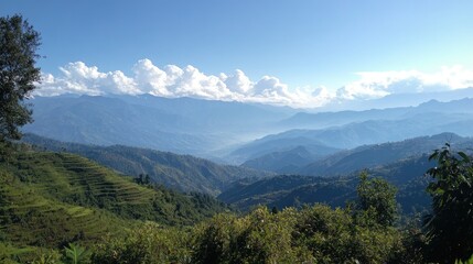 Breathtaking panoramic view of serene mountains under a clear blue sky with lush green hills in the foreground.