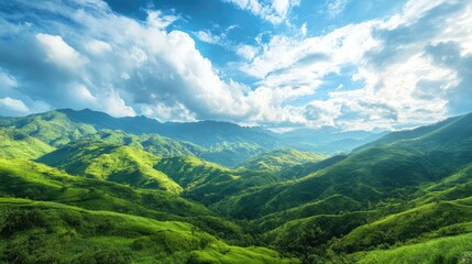 Fototapeta premium Lush green mountain landscape under a bright blue sky with clouds showcasing tranquility and the beauty of nature