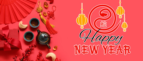 Teapot with cups of tea, fortune cookies and different Chinese symbols on red background. New Year...