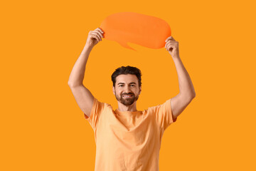 Young man with blank speech bubble on yellow background