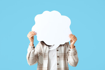 Young woman with blank speech bubble on blue background