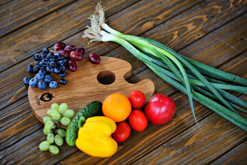 Fresh Fruits and Vegetables on a Wooden Cutting Board