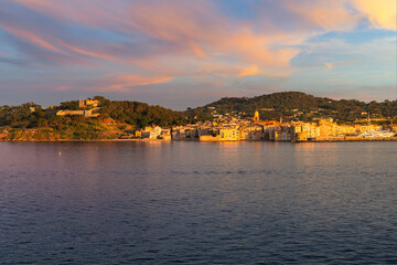 Panoramic shot of the historic old town, castle and port of Saint-Tropez, France, on the French Riviera Cote d'Azur along the Mediterranean Sea at sunset.