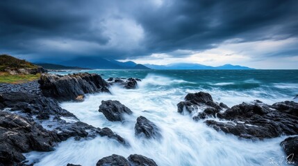 Obraz premium Majestic Turbulent Sea With Dark Clouds Over Rocky Shoreline Under Stormy Sky